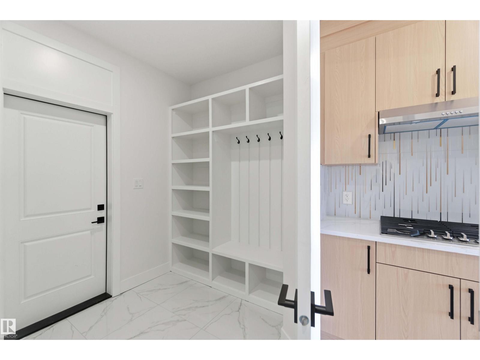 Mudroom shelving beside spice kitchen