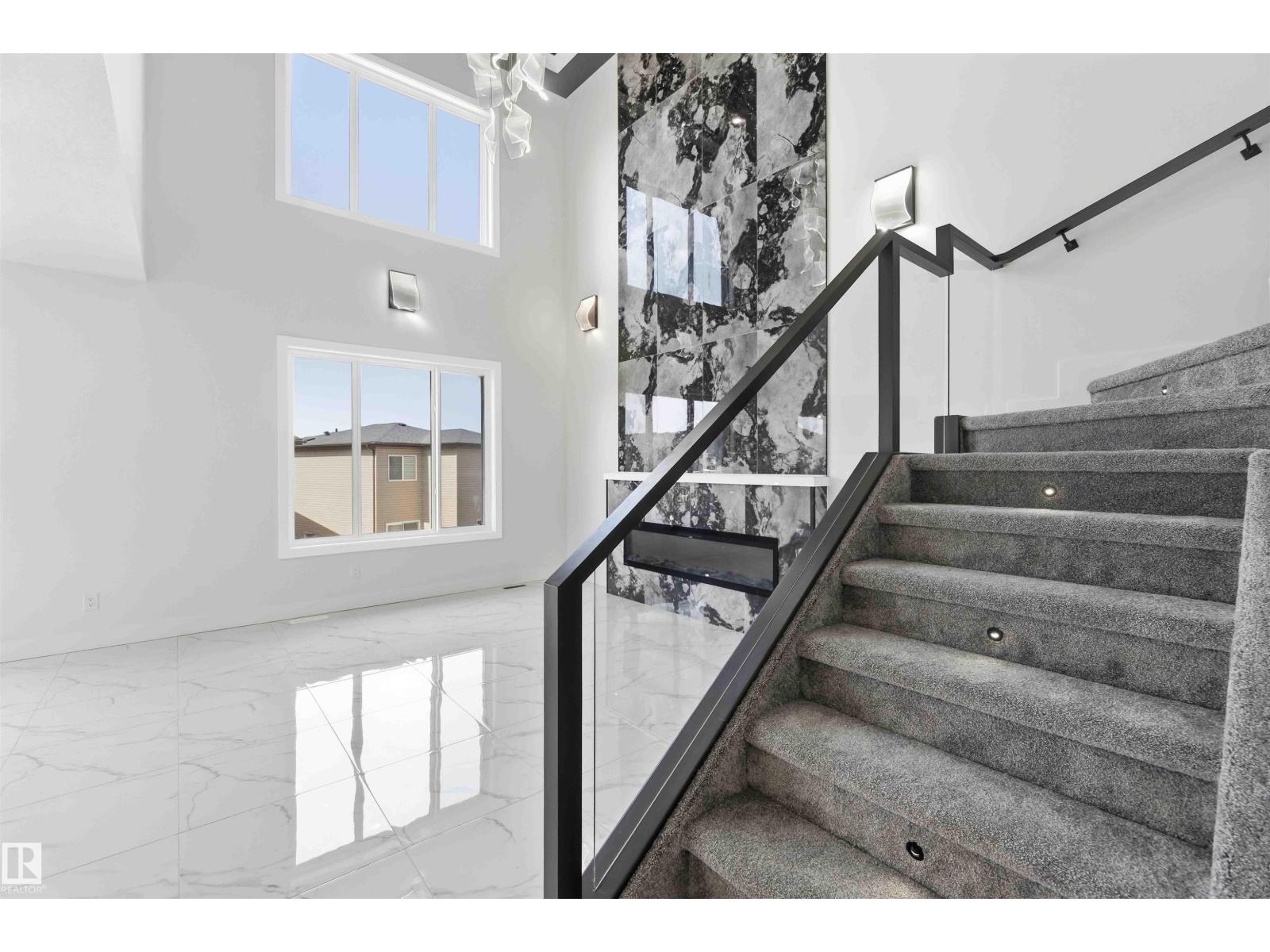 Two-storey foyer with stone fireplace wall